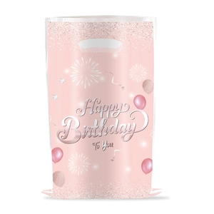 Close-up of pink pearlescent birthday gift bag with glitter balloons and silver handles