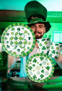 Close-up of St. Patrick's Day shamrock party plates and cups with Irish green hat motifs