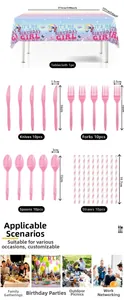 Detailed view of birthday party tableware set with blue tablecloth and pink plastic cutlery