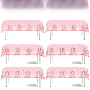 Detailed view of pink Sweet 16, 18, and 21 birthday party tablecloths with macaron design
