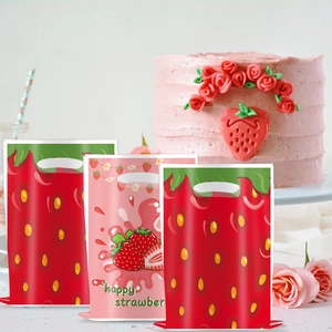 Detail of strawberry print PE gift bags featuring cutout handles for party favors