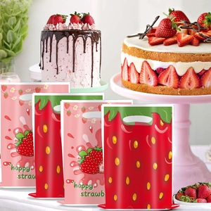 Close-up of strawberry printed PE gift bags with die-cut handles for party favors