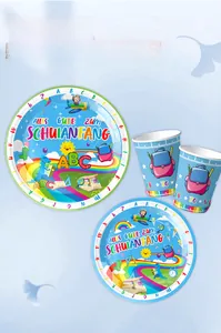 Detail of school party supplies including paper plates and cups with dinosaur motifs