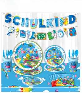 Macro detail of blue dinosaur Schulkind party tableware set with paper plates and banner