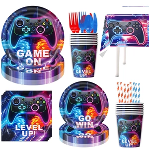 Detailed set of gamer party supplies including plates, cups, and game controller patterns