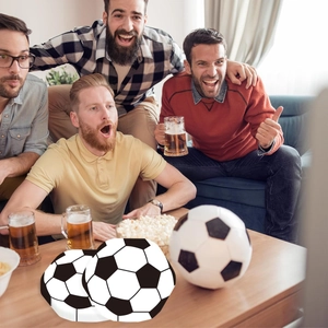 Soccer ball pattern party plates shown in a lively sports game viewing scene at home