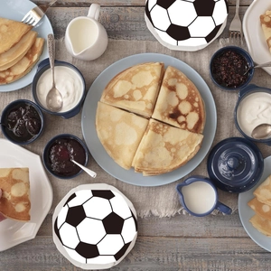 Macro shot of a soccer-themed ceramic plate featuring a black and white ball design