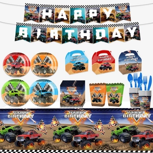 Flat lay set of monster truck birthday party supplies including plates, napkins, and banners