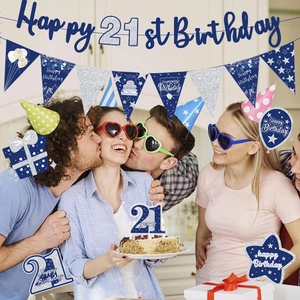 Detail of dark blue and silver 21st birthday party decorations with banners and props