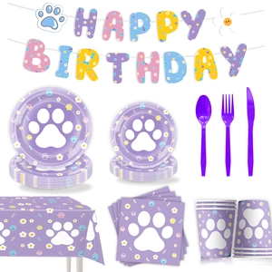 Detailed view of lilac dog paw party tableware set including plates cups and banner