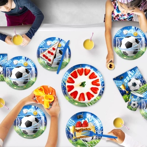 Flat lay of blue soccer party tableware set with plates, cups and napkins on table