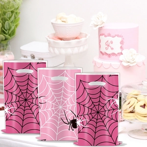 Rosa Spiderman Geburtstagstüten mit Spinnennetzmuster auf einer Desserttafel