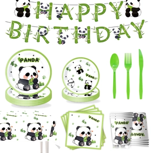 Flat lay of cartoon panda birthday party tableware set with banner, plates, and cups