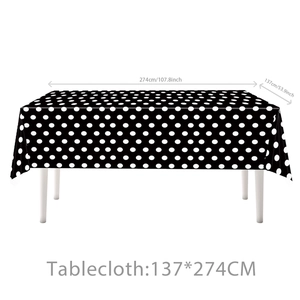 Polka dot birthday party tablecloth measuring 137x274cm with black and white pattern