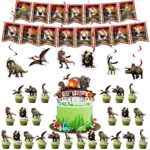 Detailed view of Jurassic dinosaur birthday banner and various cupcake topper decorations