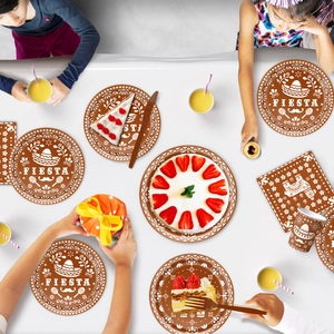 Day of the Dead fiesta party supplies set with skull plates, cups, and napkins in flat lay