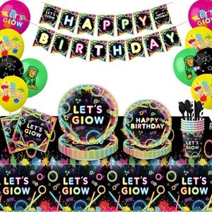 Close-up of neon disco party supplies set including plates, napkins, and glow banners