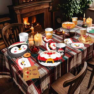 Christmas party tableware set featuring Santa and snowman patterns on festive table