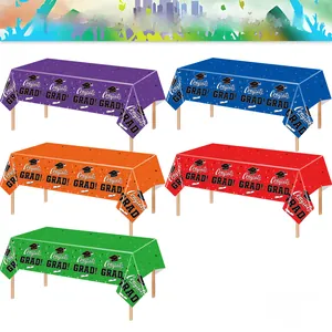 Colorful graduation party tablecloth set featuring Congrats GRAD text and cap patterns