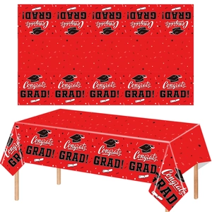 Red graduation table cover with white Congrats GRAD text and black cap patterns