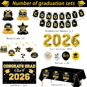 Detailed flat lay of black and gold 2026 graduation party supply set with balloons and banners