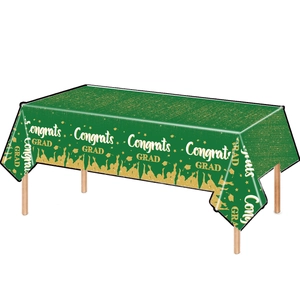 Green and gold Graduation tablecloth with Congrats GRAD lettering and graduation caps