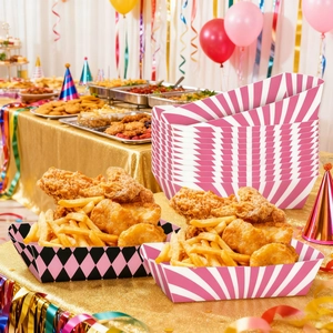 Pink cowgirl themed party food trays featuring striped and checkered patterns on a buffet table