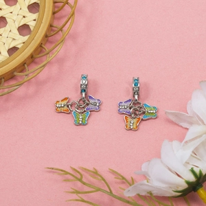 Colorful butterfly pendants with zircons for DIY jewelry making on aesthetic background