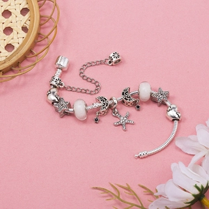 DIY star and moon charm bracelet in silver with starfish pendants and glass beads