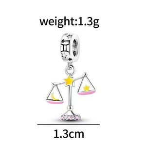 Silver Libra zodiac charm with pink enamel and star details, 1.3cm height macro view