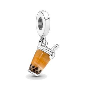 Macro shot of silver metal bubble tea charm with orange resin and black pearl details