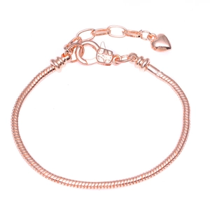 Close-up of rose gold snake chain bracelet with lobster clasp and heart pendant detail