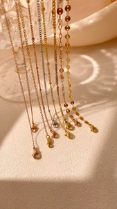 Detail of silver, gold, and rose gold necklaces with lobster clasps and varied chain links