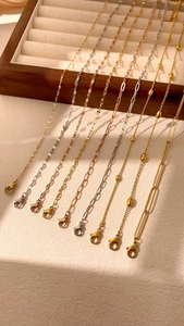 Detail of assorted silver and gold layered chains with secure lobster claw clasps