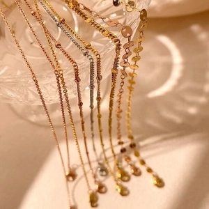 Elegant silver and gold layered necklaces with minimalist pendants and chain styles