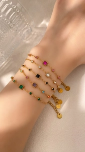 Detail of five-piece gold geometric bracelet set with multicolored crystals and S925 tag