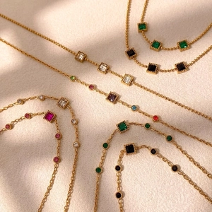 Minimalist gold link bracelets and necklaces with colorful gemstones in various shapes