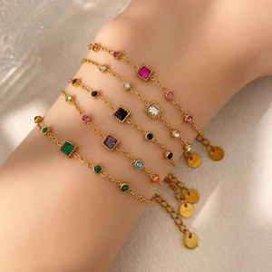 Minimalist gold stainless steel bracelets with colorful geometric gems on female wrist