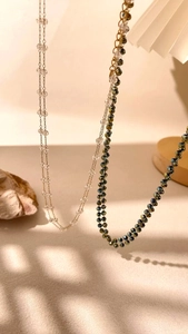 Detail of double-layer bohemian necklaces featuring crystal beads and adjustable clasps