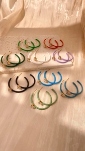 Detailed set of nine colorful C-shaped hoop earrings with sparkling zircon inlay