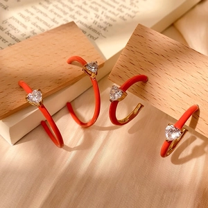 Elegant C-shaped orange enamel hoop earrings with heart-shaped zircon stones