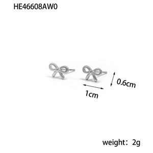 Macro detail of silver bow stud earrings showing dimensions 1cm x 0.6cm and weight 2g