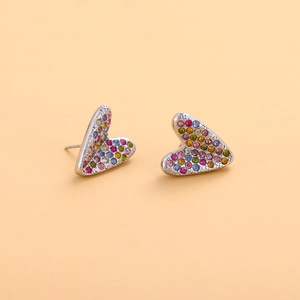 Gros plan sur les clous d'oreilles cœur argentés avec strass multicolores brillants