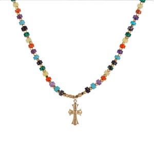 Macro shot of colorful beaded necklace with a golden vintage cross pendant charm