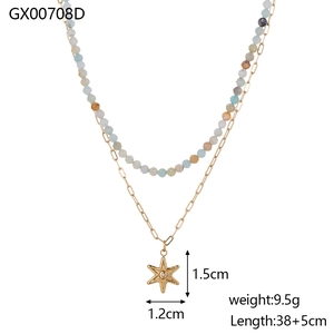 Detail view of double-layer natural stone necklace with a gold star pendant