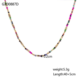 Detail of colorful faceted stone beads and gold cube accents on the beaded necklace