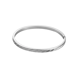 Macro detail of silver stainless steel bangle with diagonal texture and hinge clasp