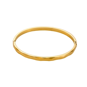 Detail of gold-plated stainless steel bangle with irregular geometric hammer textures