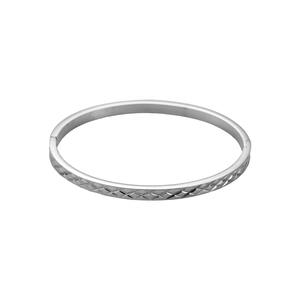 Detail of silver stainless steel bangle showing intricate diamond texture and hinge closure