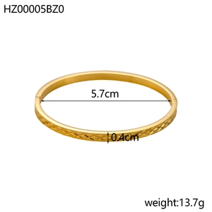 Detailed view of 5.7cm diameter gold titanium bracelet with diamond pattern and clasp
